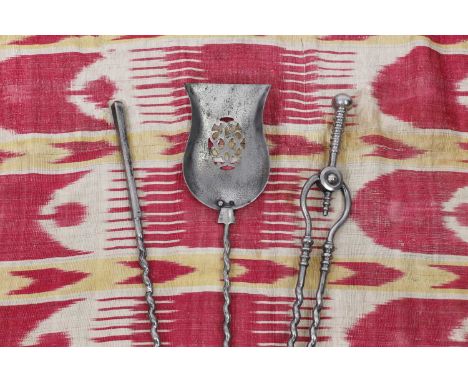 A set of George III polished steel fire tools, comprising a shovel, poker and tongs, all with twisted stems, 71cm long (3)Con