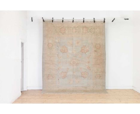 An Oushak wool carpet of Ziegler design,of recent manufacture, with bold foliate decoration to a pale ground,307 x 240cmCondi