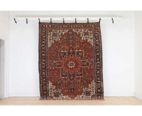 A Persian Heriz wool rug, first half of the 20th century, woven with geometric floral and foliate motifs,269 x 208Condition R