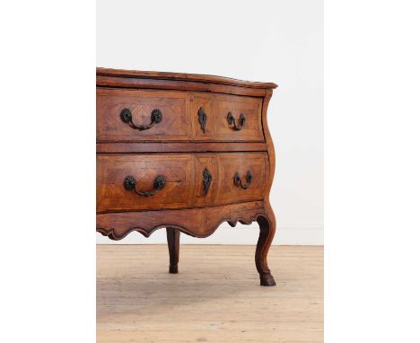 A walnut and marquetry commode, mid-18th century, Italian, of serpentine outline, the top inlaid with a star and quadrilobed 