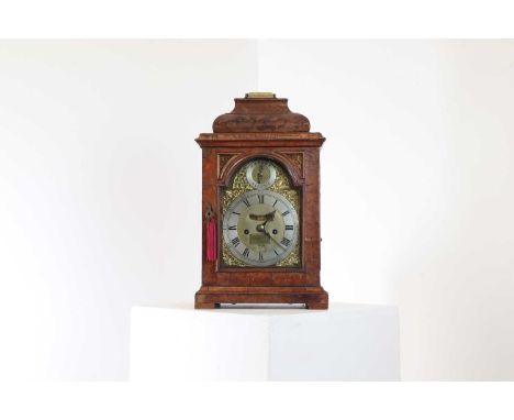 A walnut bracket clock, first quarter of the 18th century, the case with a moulded pediment and variously shaped glass panels