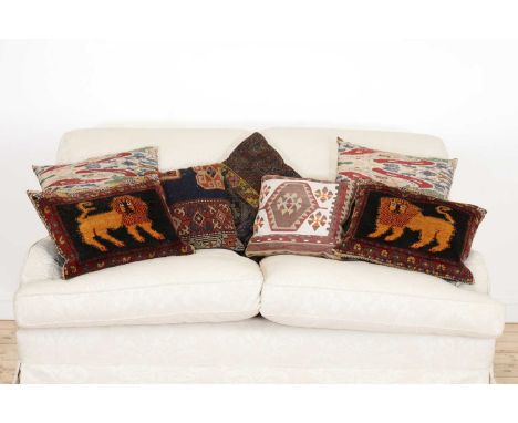 A group of seven cushions,20th century, in various designs, including two ikat printed, a needlepoint with kilim design, and 