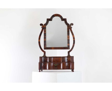 A walnut table dressing table mirror,18th century, of angular cartouche form, with a laburnum cross-cut moulding and veneered