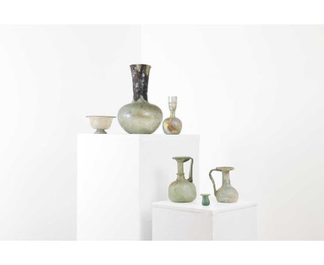 A collection of Roman glass vessels,3rd to 4th century, comprising:two jugs, 10.5 and 13.5cm high,a vase with trailed decorat