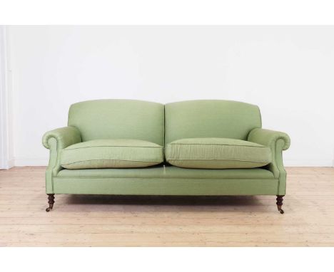 A two-seater sofa by George Smith,late 20th century, with short scroll arms and turned front supports, terminating in brass c