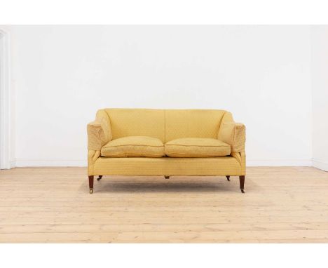 A small upholstered sofa by Howard &amp; Sons, first quarter of the 20th century, with downswept arms and tapering square sup