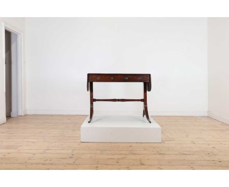 A Regency mahogany and rosewood banded sofa table,c.1810, with two frieze drawers and splayed supports united by a turned str