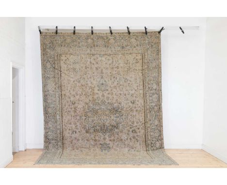 A Persian wool carpet,20th century, woven with foliate motifs to a pale field,368 x 272cmCondition ReportExtensive wear and f