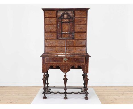 A yew wood and walnut cabinet on stand,18th century and later, the moulded frieze above a central compartment and an arrangem