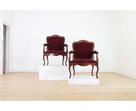 A pair of Louis XV-style fauteuils,20th century, each with open arms and raised on cabriole supports, the back and drop-in se