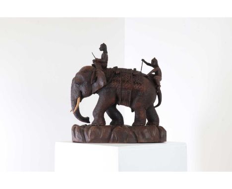A carved teak figure of an elephant, late 19th/early 20th century, Indian, set with a pair of mahouts,18cm wide44cm deep44cm 