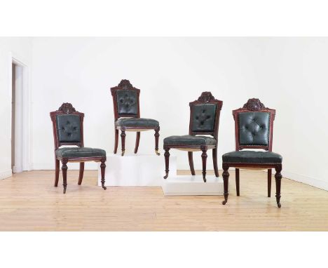 A set of four Victorian walnut dining chairs, c.1870, Irish, each rail carved with the coat of arms of Clotworthy Skeffington