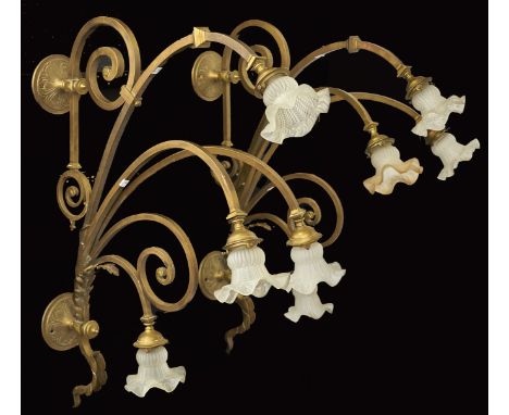 A pair of French brass four light wall sconces, second quarter 20th c, of four arched branches, two surmounted by scrolls, 94