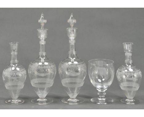 A pair of British glass decanters and stoppers and a pair of smaller decanters en suite, c1900, etched with bands of grapevin