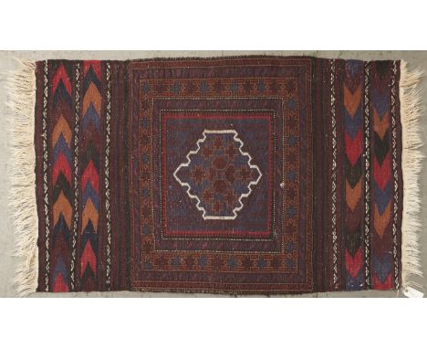 A modern Caucasian kilim, worked to the centre with a geometric medallion in brown and indigo framed in white within a square