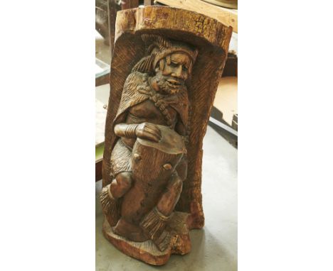An African tree trunk carving of a man with a drum, 20th c, 85cm h  Good condition