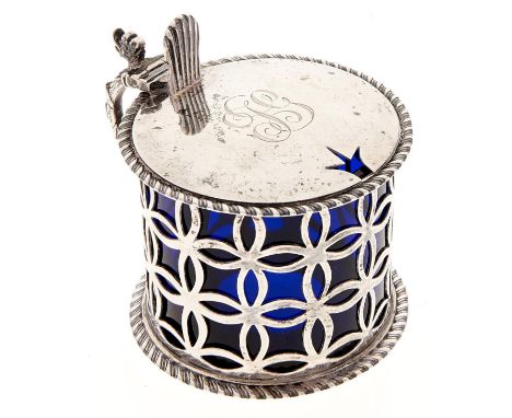 An Edwardian diaper pierced silver mustard pot, with grotesque handle and gadrooned rims, blue glass liner, 65mm h, by W Hutt