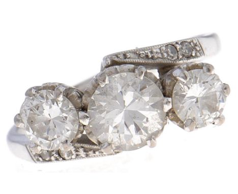 A three stone diamond crossover ring,&nbsp; with round brilliant cut diamonds, central stone weighing approx 0.75ct, diamond 