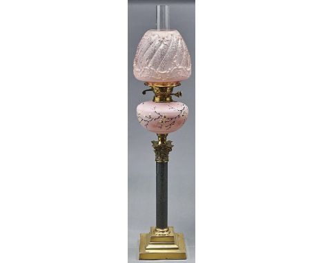 A Victorian brass mounted columnar oil lamp, c1900, with serpentine shaft and pink satin glass fount, enamelled with prunus, 