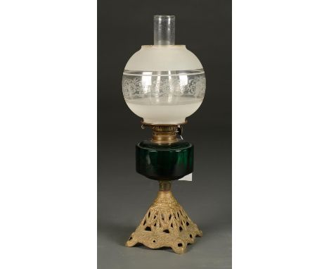 A Victorian painted cast iron oil lamp, the openwork pyramidal foot supporting dark green glass fount, brass burner, etched g