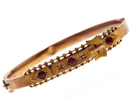 A Victorian red and white paste set gold bangle, late 19th c, 9g  One small clear paste deficient; lower half dented