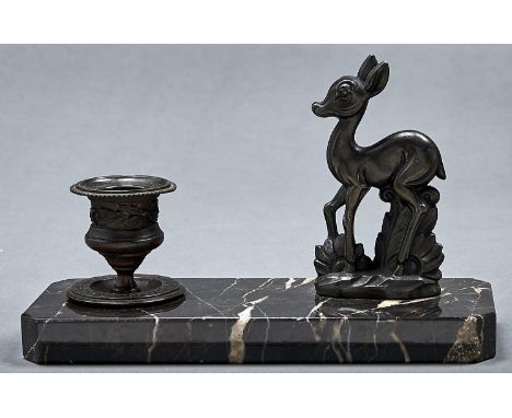 An Art Deco style candle stand, the cantered rectangular striated black marble base fitted bronzed deer flanking a replaced r