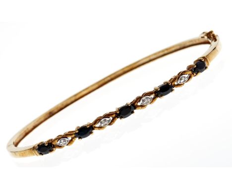 A sapphire and diamond bangle, in two colour 9ct gold, 7.4g  Good condition