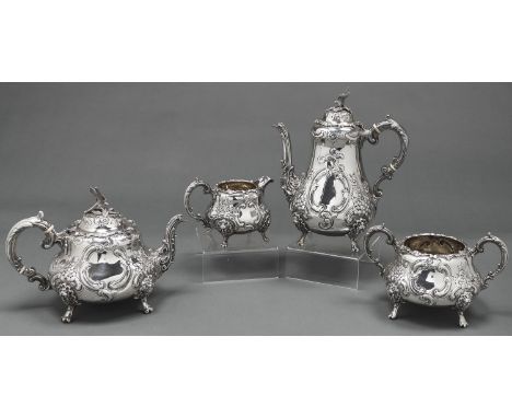 A Victorian silver pear shaped tea and coffee service, chased with flowers and foliage, the domed lid with eagle finial, coff