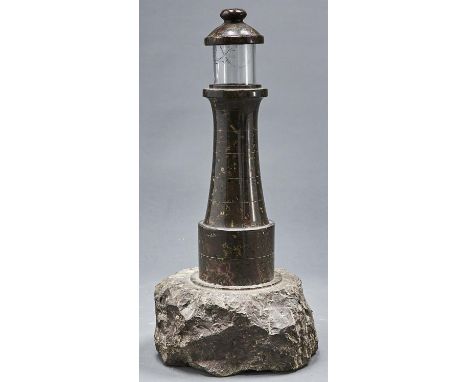 A Cornish serpentine table lamp in the form of a lighthouse, c1920, 48cm h  Cylindrical glass shade damaged