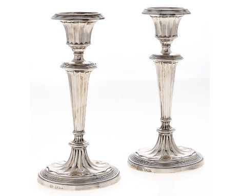 A pair of George V silver candlesticks, in neo classical style, of fluted form on oval foot, nozzles, 18.5cm h, by The Alexan