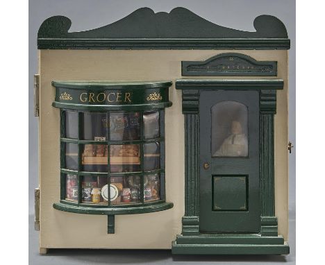 A reproduction illuminated table top display shop for 'M. Thatcher, Grocer', late 20th c, the interior fully fitted with figu