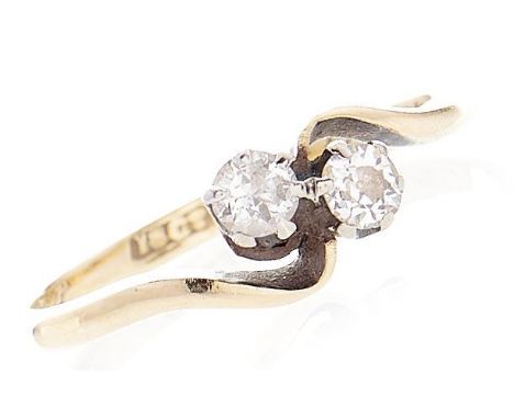A diamond crossover ring, in gold marked 18ct, 1.6g, size I  Wear consistent with age, engraved initials inside