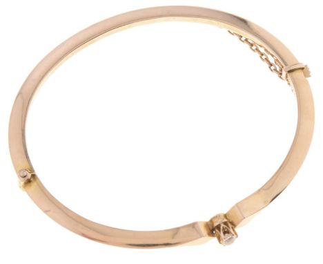 A diamond bangle, early 20th c, in gold, the old cut diamond weighing approximately 0.2ct, marked 15ct, 6g  Good condition, c