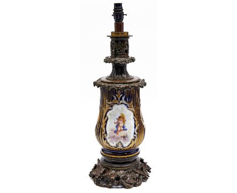 A French oxodised brass mounted cobalt ground porcelain oil lamp, c1870, the Sevres style, the reeded baluster vase painted w