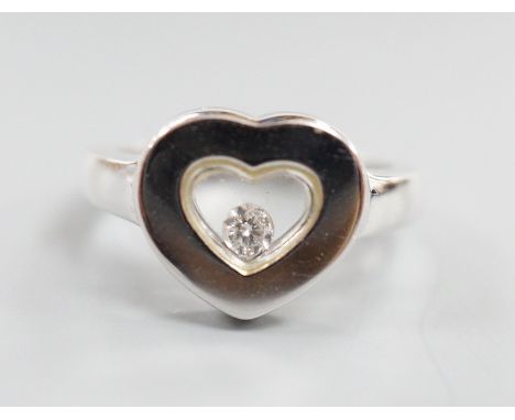 A modern 750 white metal and 'floating diamond' heart shape dress ring, size M, gross weight 6.4 grams.