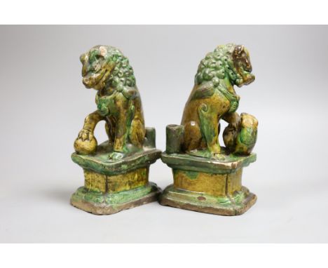 A pair of Chinese sancai lion dog joss-stick holders, late Ming dynasty,20cm high,