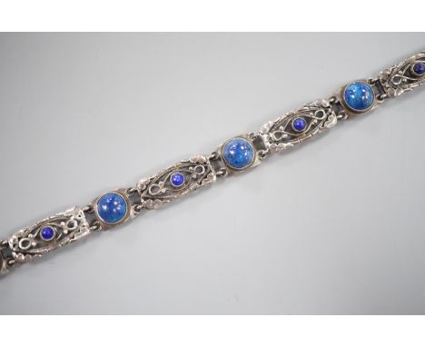 A stylish early 20th century white metal and two colour ten stone lapis lazuli?? or possibly enamel?? cabochon set bracelet, 