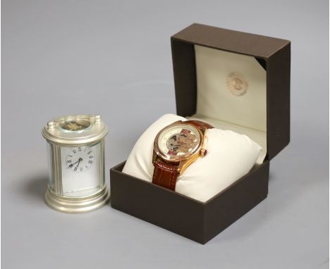 A circular plated carriage clock with key and a Victoria Cross gent's wristwatch