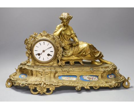 A 19th century French gilt metal figural mantel clock, with porcelain floral panels,30cms high.