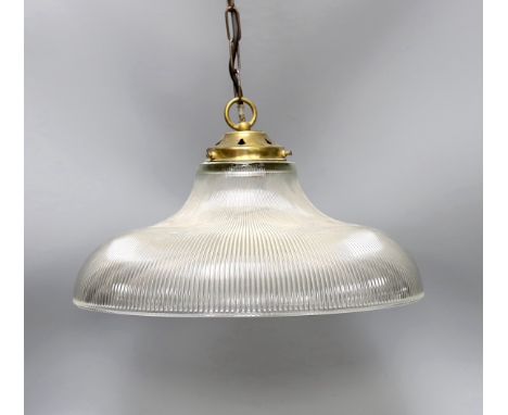 A clear ribbed glass shaded and brass pendant light,shade 37.5 cms diameter.