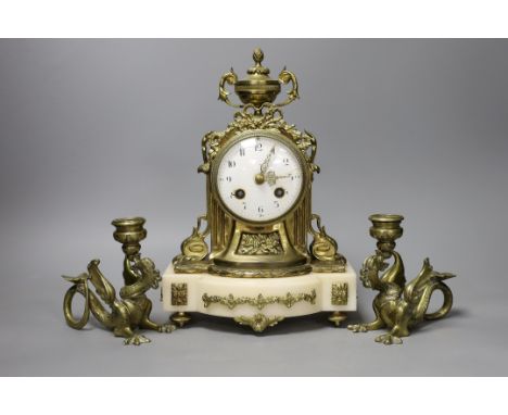 A 19th century French brass and alabaster mantel clock and a pair of dragon candlesticks,clock 28cms high,