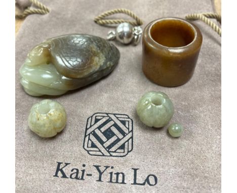 Kai Yin Lo of Hong Kong, a jade turtle and snake pendant, jade archer’s ring and two beads, formerly strung on a necklace tog