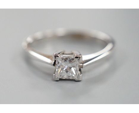 A modern 750 white metal and solitaire princes cut diamond set ring, size L/M, gross weight 2.6 grams, diamond weight approx.