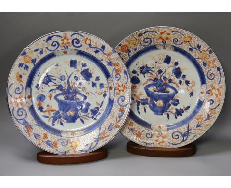 A pair of Chinese Imari dishes, Kangxi period, on wooden stands,31 cms diameter.Provenance - D.C.Monk &amp; Son, former deale