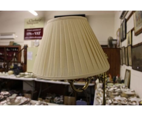 A brass standard lamp and shade