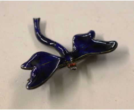 A sterling silver and enamel decorated inset brooch