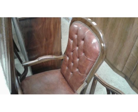 A brown leather button back elbow chair