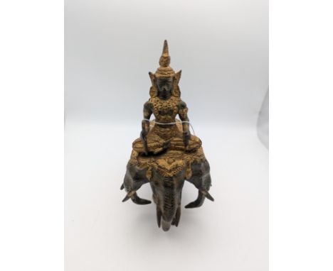 A Thai Hindu cast metal figure of a figure riding a three headed elephant, measuring 19.5cm highLocation: R1.2If there is no 