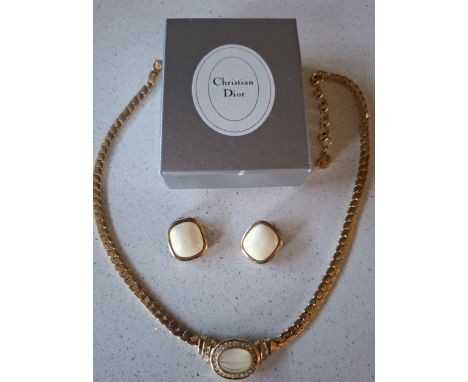 Christian Dior- A matched jewellery suite comprising a yellow tone necklace with central opaque cream and faceted glass stone