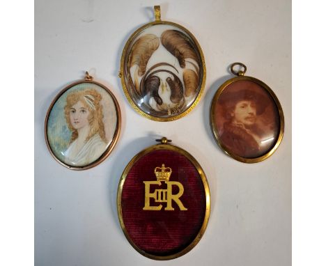 A large Victorian Pinchbeck framed mourning pendant depicting a portrait of an elderly gent, the reverse set with 5 locks of 